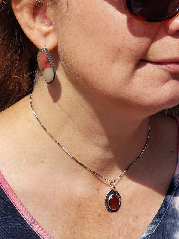 Woman wearing orange necklace and earrings