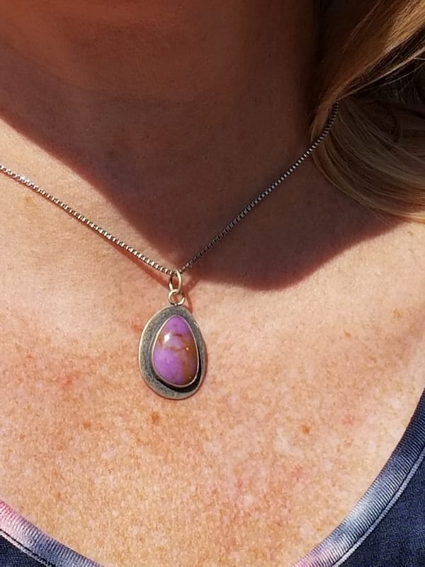 Woman wearing purple necklace
