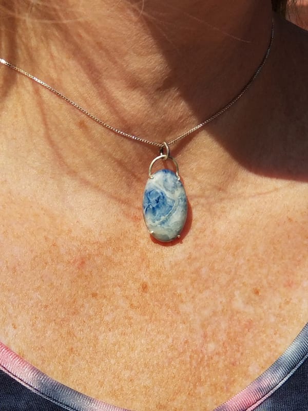 Woman wearing blue stone necklace