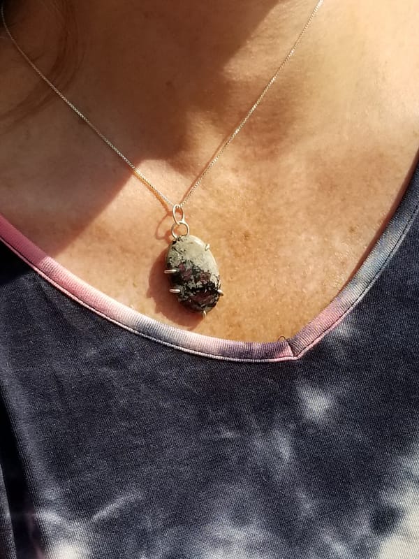 Woman wearing black and red stone necklace